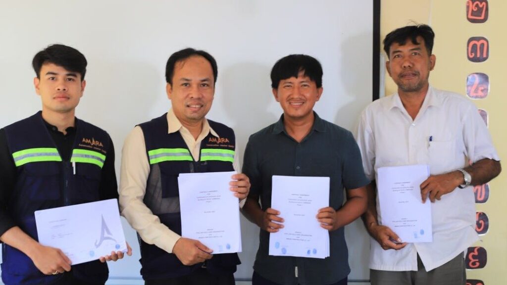 Four men showing their diplomas.